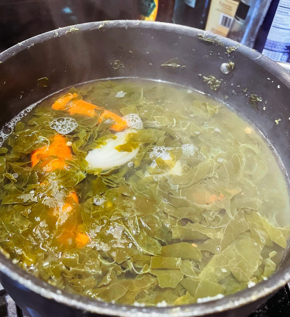 Cooking Polish sorrel soup in a large pot